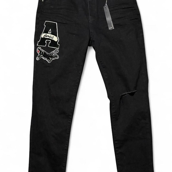Black Amiri skinny jeans with embroidered logo and distressed details